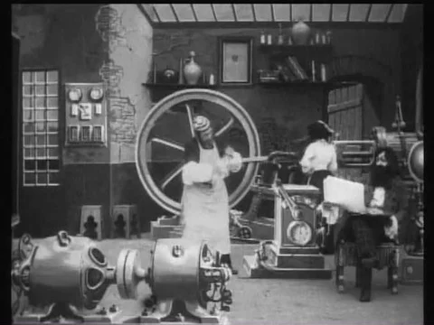 After his studio has been cleaned up, an inventor greets some visitors in 1908. Stock Footage 75757886