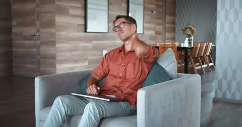 After hours at computer man experiences neck pain and fatigue This fatigue Stock Footage 259898280