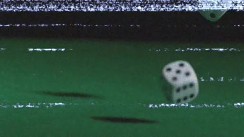 After initial toss, two white dice rolling and tumbling right across green felt, Stock Footage 323407204