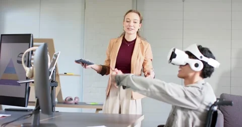After introducing VR, female coworker demonstrating VR simulation at desk Stock Footage 340972745