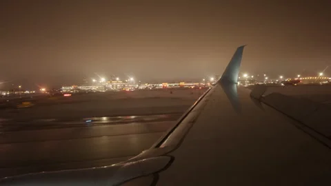 After landing plane moves along runway at night against background of bright Stock Footage 309016551