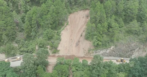 After the landslide, people actively worked to clear the road Video stock 337985325