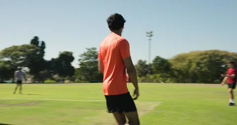After marking run-up, asian man bowler conferring umpire, sprinting in bowling Stock Footage 342111255