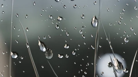 After merging droplets forming long streaks and sliding down glass, pulled by Stock Footage 341889676