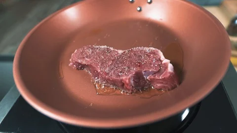 After preparation, The chef put the beef in the hot olive oil Stock Footage 128750829