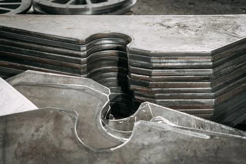 After processing on the machine, the metal sheets are neatly stacked Stock Photos