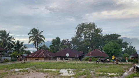 After the rain at the central place in a small Indonesian village with homes Stock Footage 281326283