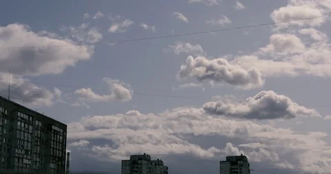 After rain, clouds quickly float across the sky above the city Stock Footage 116188073