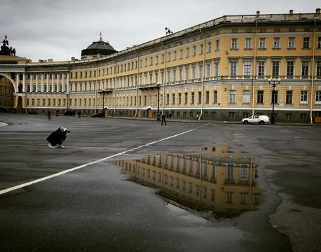 After the rain with a puddle on the square in the style of classicism Stock Photos