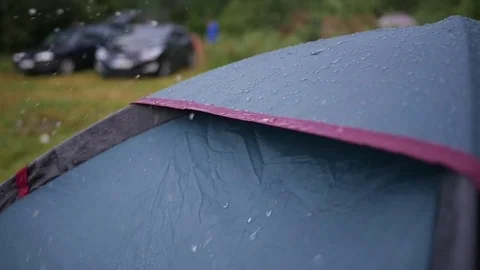 After the rain shake the drops from the camping tent in slow motion Video stock 77483875