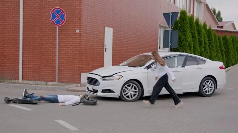 After a road accident, the driver immediately stops and runs to the man who is Stock Footage 246828715
