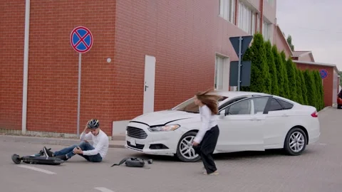 After a road accident, the driver immediately stops and runs to the man who is Stock Footage 248175094