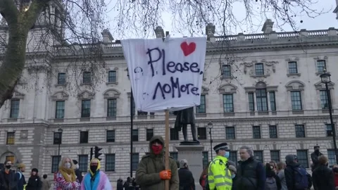 AFTER SARAH EVERARD'S DEATH A PROTESTER CARRIES PLACARD SAYING PLEASE NO MORE Stock Footage 150381966