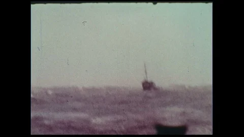 After spending time fighting the roaring seas, a boat settles as waves begin to Video stock 74520958