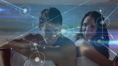 After start couple sitting on beach while node network surrounding them in Stock Footage 313241596