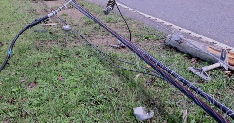 After a storm hurricane, damaged power lines lie crashed on ground with broken Vídeo Stock 287206466
