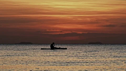 After sunset glowing sky with sitting silhouette on sup board Stock Footage 330873721