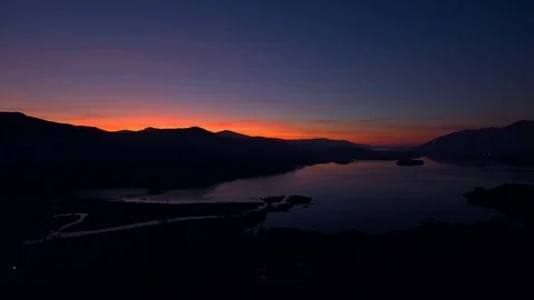 After sunset orange glow over lake and mountains. Stock Footage 118440925