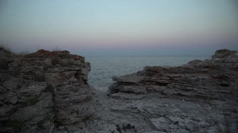 After Sunset at the Rocks by the Sea 4K Stock Footage 66561653