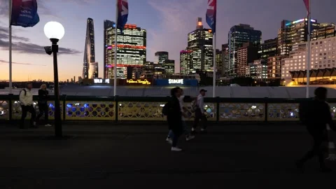 After sunset Sydney commuters use Pyrmont Bridge tracking shot 6K Stock Footage 310708142