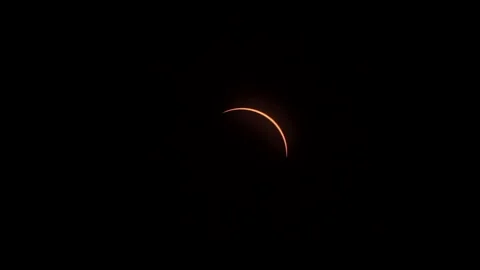 After the totality phase of a solar eclipse, a sliver of sunlight Stock Footage 274042018
