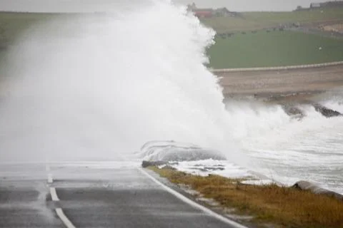 After two days of storm force southerly winds the sea was whipped up and batt Stock Photos