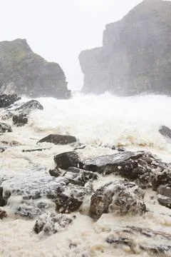 After two days of storm force southerly winds the sea was whipped up and batt Stock Photos