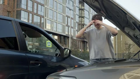 After visually assessing damage to his car in accident, driver was appalled. Stock Footage 310457711