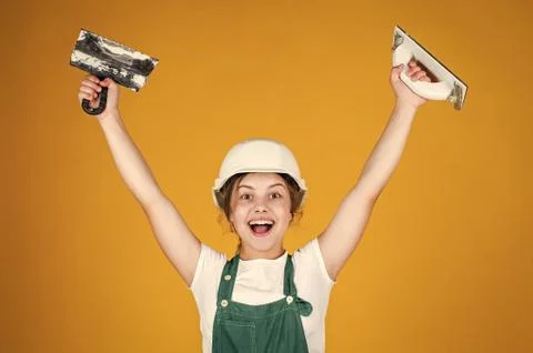 After the work is done. kid bricklayer masonry worker with helmet and putty Stock Photos
