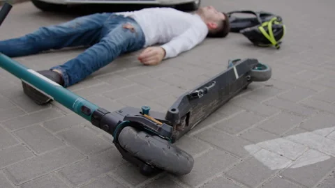 Aftermath of accident car collided with electric scooter leaving scooter driver Stock Footage 272957948
