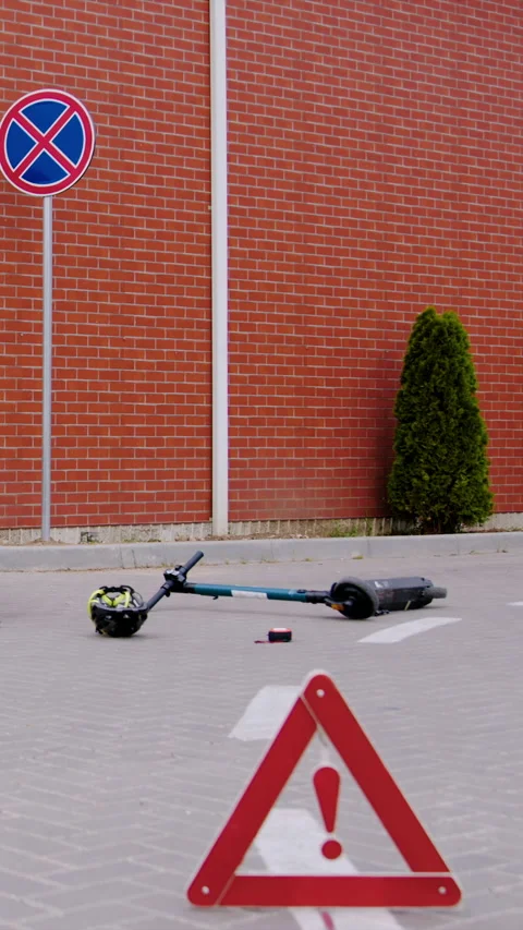 Aftermath of collision between automobile electric scooter broken scooter lies Stock Footage 275158074