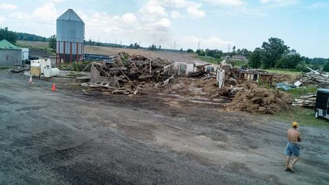 Aftermath of Controlled Barn Burn and Ruin Demolition with Large Hay Piles Stock Photos