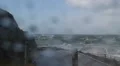Aftermath of Hurricane Gonzalo- wind causes water to run along pavement HD Footage