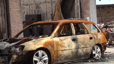 Aftermath from a major fire - burned car and building Stock Footage 309420989