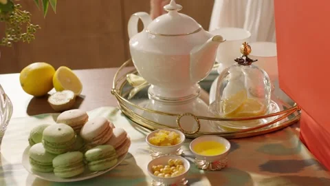 Afternoon Tea Set with Macarons, Lemon and Teapot on Table Video stock 327594076