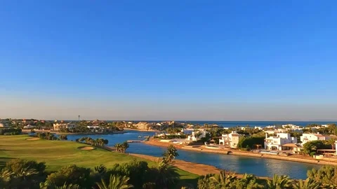 Afternoon view over golf course and sea Stock Footage 197950615