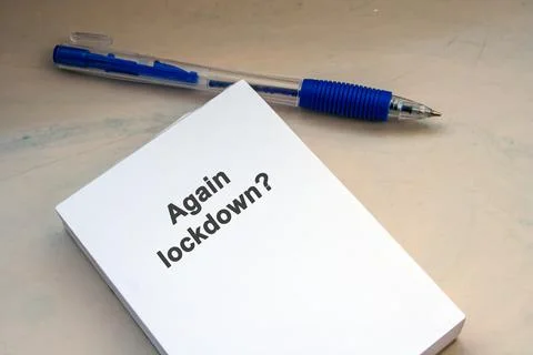 Again lockdown question. Paper note and pen. Message on note. Coronavirus Stock Photos