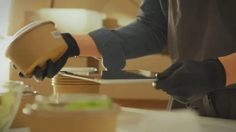 Against the backdrop of boxes of groceries, a warehouse manager, working wit Stock Footage 266156191