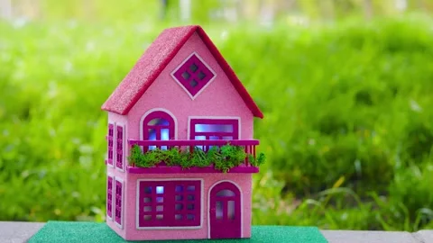 Against the backdrop of swaying green grass, a house with a red roof Stock Footage 306526142
