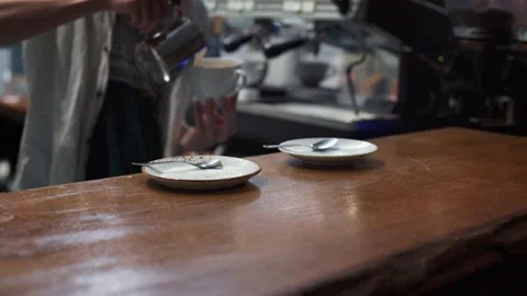 Against the background of the bar table, the barista prepares coffee. Video stock 165001440