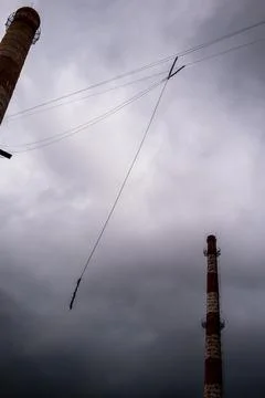 Against the background of a blue sky with clouds hangs a mount for rope jumpi Stock Photos