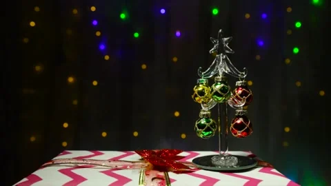 Against the background of bright lights, a small Christmas tree Stock Footage 144609530