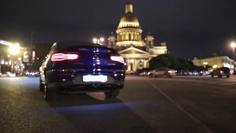 Against the background of the building, the car is driving across the square. Stock Footage 150106884