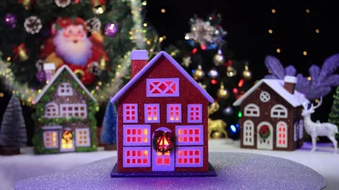 Against the background of Christmas trees an orange house rotates Stock Footage 286298282