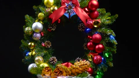 Against the background of a Christmas wreath a vase with cones revolves Stock Footage 166340523