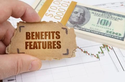 Against the background of dollars and a chart of quotations, a man holds a si Fotos Stock
