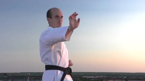 Against the background of the evening sky, is training blocks and punches Stock Footage 139487631