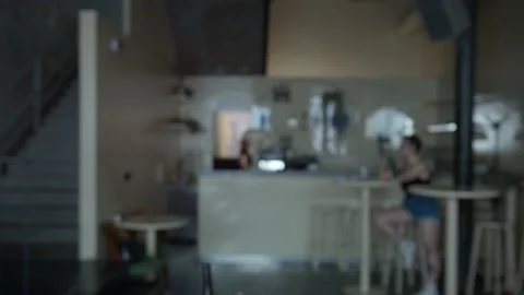 Against the background of hipster cafe, close-up hand up raises a sandwich with Video stock 132336478