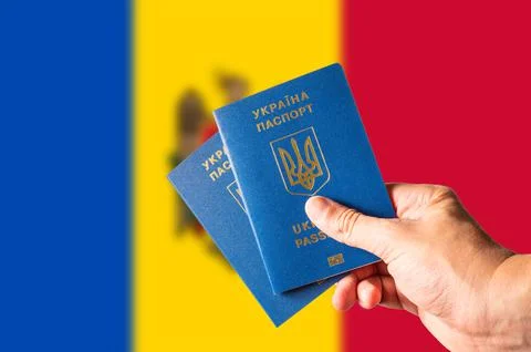 Against the background of the national flag of Moldova, two Ukrainian biometr Stock Photos