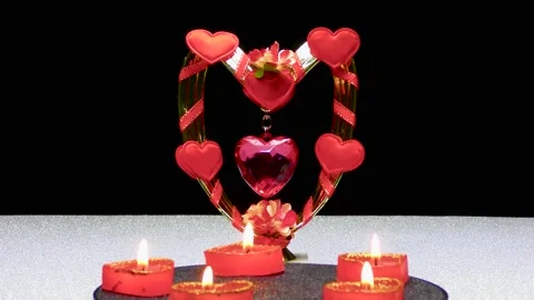 Against the background of a romantic composition of hearts, burning candles Stock Footage 168788234